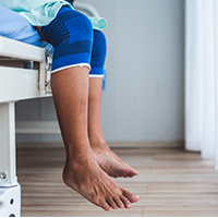 image of a patient's legs waiting to see a doctor